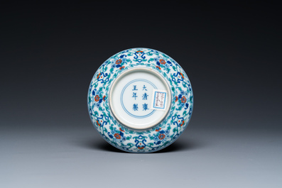 A Chinese doucai saucer with floral design, Yongzheng mark, 19/20th C.