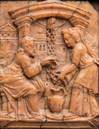 A Malines alabaster relief carving depicting Christ meeting the Samaritan woman at the well, Flanders, early 17th C.