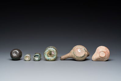 Four Roman glass bottles, two pottery oil lamps and a bowl