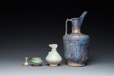 Three blue- and turquoise-glazed Islamic pottery wares and a glass bottle, Kashan and Raqqa, 12th C. and later