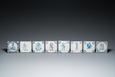 Eight Dutch Delft blue and white tiles with a jester, craftsmen at work and playing children, 17th C.