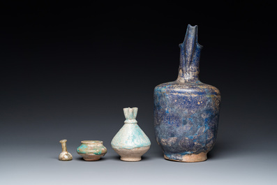 Three blue- and turquoise-glazed Islamic pottery wares and a glass bottle, Kashan and Raqqa, 12th C. and later