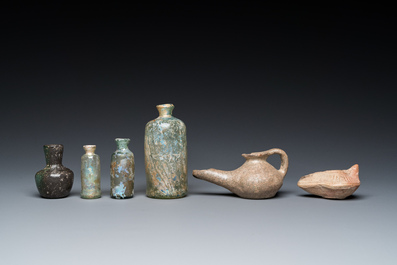 Four Roman glass bottles, two pottery oil lamps and a bowl