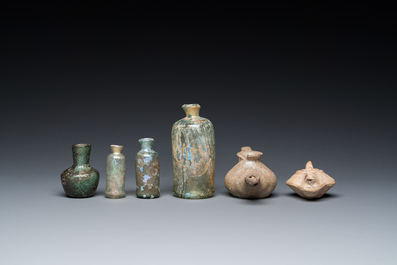 Four Roman glass bottles, two pottery oil lamps and a bowl