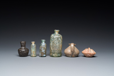 Four Roman glass bottles, two pottery oil lamps and a bowl