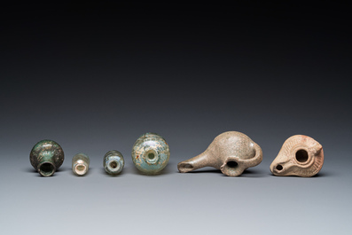 Four Roman glass bottles, two pottery oil lamps and a bowl