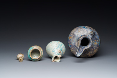 Three blue- and turquoise-glazed Islamic pottery wares and a glass bottle, Kashan and Raqqa, 12th C. and later