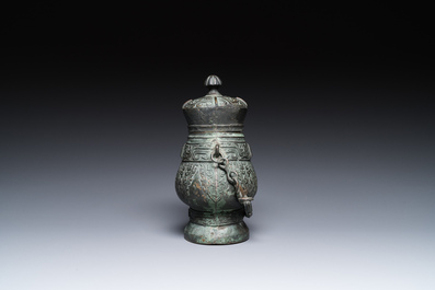 A Chinese archaic bronze ritual 'you' wine vessel and cover in Western Zhou-style, Ming