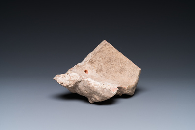 A Greek terracotta with white engobe antefix in the shape of a woman's head, 5/4th C. b.C.