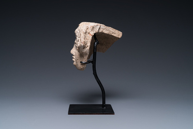 A Greek terracotta with white engobe antefix in the shape of a woman's head, 5/4th C. b.C.