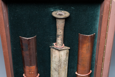 A Chinese bronze dagger with wooden scabbard in a display case, Han