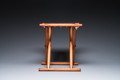 A Chinese wooden mirror and a foldable stool, 19/20th C.