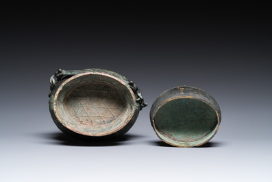 A Chinese archaic bronze ritual 'you' wine vessel and cover in Western Zhou-style, Ming