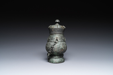 A Chinese archaic bronze ritual 'you' wine vessel and cover in Western Zhou-style, Ming