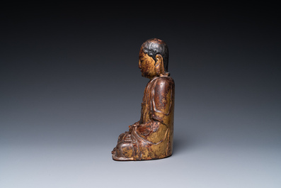 A Chinese gilt-lacquered wood sculpture of an Arhat, Ming