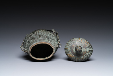 A Chinese archaic bronze ritual 'you' wine vessel and cover in Western Zhou-style, Ming
