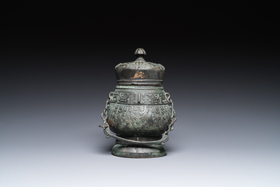 A Chinese archaic bronze ritual 'you' wine vessel and cover in Western Zhou-style, Ming