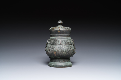 A Chinese archaic bronze ritual 'you' wine vessel and cover in Western Zhou-style, Ming