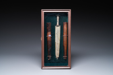 A Chinese bronze dagger with wooden scabbard in a display case, Han