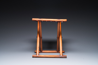 A Chinese wooden mirror and a foldable stool, 19/20th C.