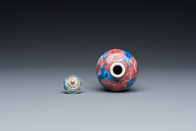 A Chinese blue, white and copper-red 'dogs' snuff bottle, 19th C.