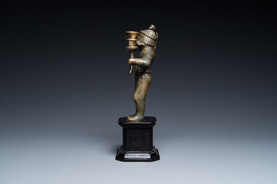 A rare bronze 'wild man' candlestick, Flanders or Germany, 15/16th C.