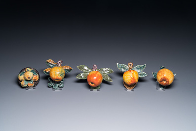 Four polychrome Dutch Delft hanging models of apples and a rare table piece with apples and pears, 18th C.
