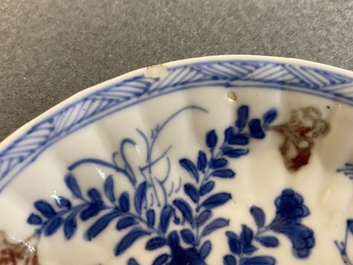 A Chinese blue, white and copper-red cup and saucer, Kangxi