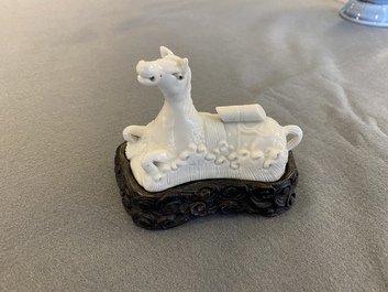 A Chinese white-glazed brush rest in the shape of a resting horse in a wavy sea, 18th C.