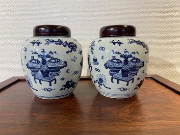 A pair of Chinese blue and white &lsquo;antiquities&rsquo; jars with wooden covers, Kangxi