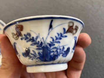 A Chinese blue, white and copper-red cup and saucer, Kangxi