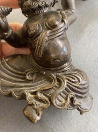 A Chinese bronze censer and cover in the shape of a Luohan on a Buddhist lion, late Ming/early Qing