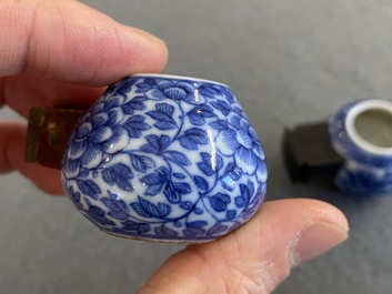 Four Chinese blue, white and copper-red bird feeders, 19th C.