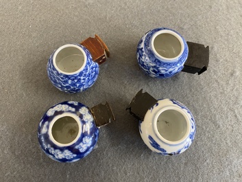 Four Chinese blue, white and copper-red bird feeders, 19th C.