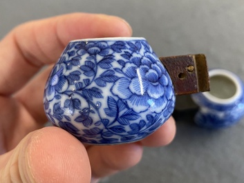 Four Chinese blue, white and copper-red bird feeders, 19th C.