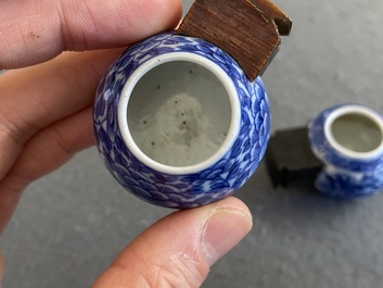 Four Chinese blue, white and copper-red bird feeders, 19th C.