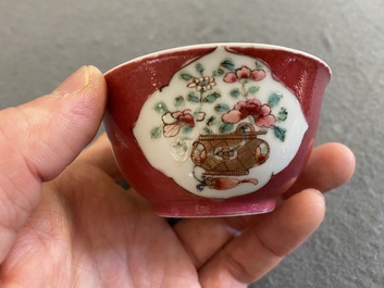 A Chinese famille rose ruby-ground cup and saucer, Yongzheng