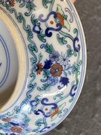 A Chinese doucai saucer with floral design, Yongzheng mark, 19/20th C.