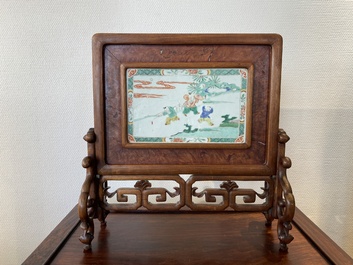 A Chinese famille verte plaque set in a partly huanghuali wooden table screen, Kangxi