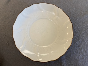 A Chinese lotus-molded white-glazed plate with incised lotus design, Xuande mark, Transitional period