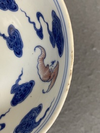 Een Chinees blauw-wit en koperrood bord met vleermuizen tussen wolken, Qianlong merk maar wellicht later