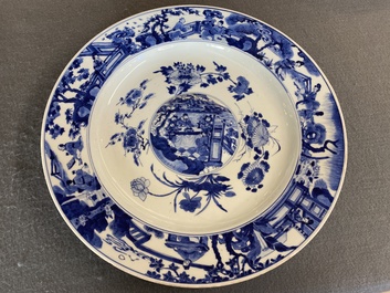 A large Chinese blue and white dish with raised central medallion, Kangxi