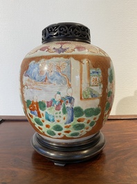 A Chinese famille rose 'mandarin subject' jar with wooden cover and stand, Qianlong/Jiaqing