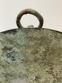 A large Chinese bronze mirror with turquoise and gold or gilt silver inlays, Warring States Period