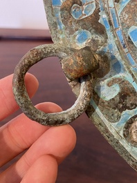 A large Chinese bronze mirror with turquoise and gold or gilt silver inlays, Warring States Period