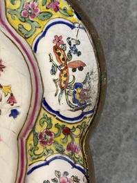 A lobed Chinese Canton enamel plate with a lady and two boys in a garden, Yongzheng