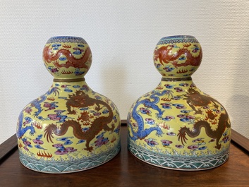 A pair of Chinese famille rose yellow-ground 'dragon' vases, Qianlong mark, 20th C.