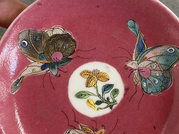 A rare Chinese famille rose ruby-ground 'three butterflies' saucer, Yongzheng