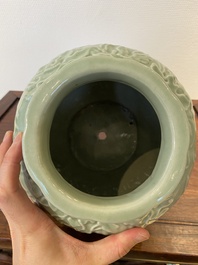 Een Chinese monochrome celadon-geglazuurde vaas met reli&euml;fdecor, 19/20e eeuw