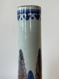 A Chinese blue, white and copper-red bottle vase with a deer and birds among blossoming branches, 19th C.